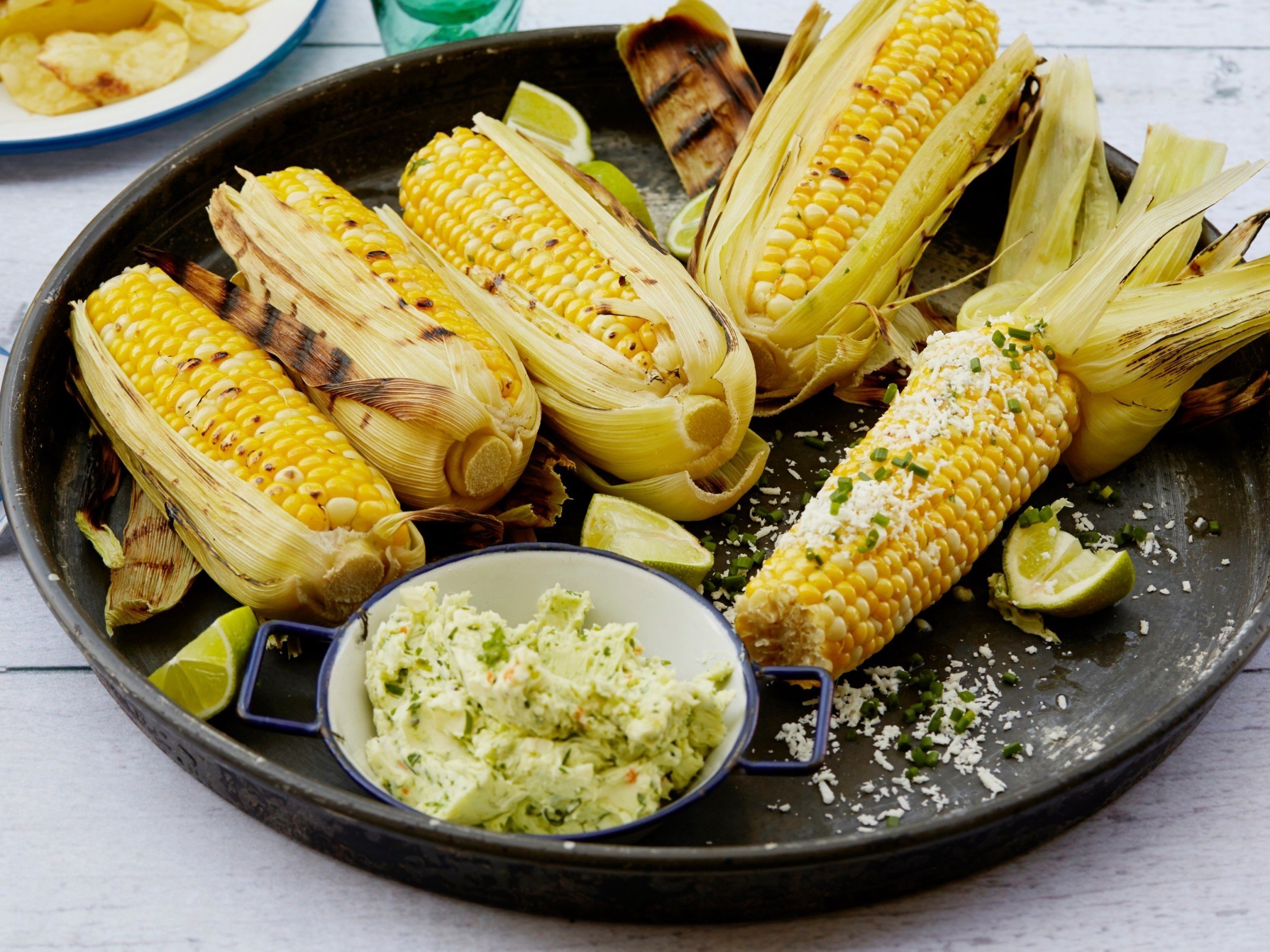 grilled corn on the cobs on a plate