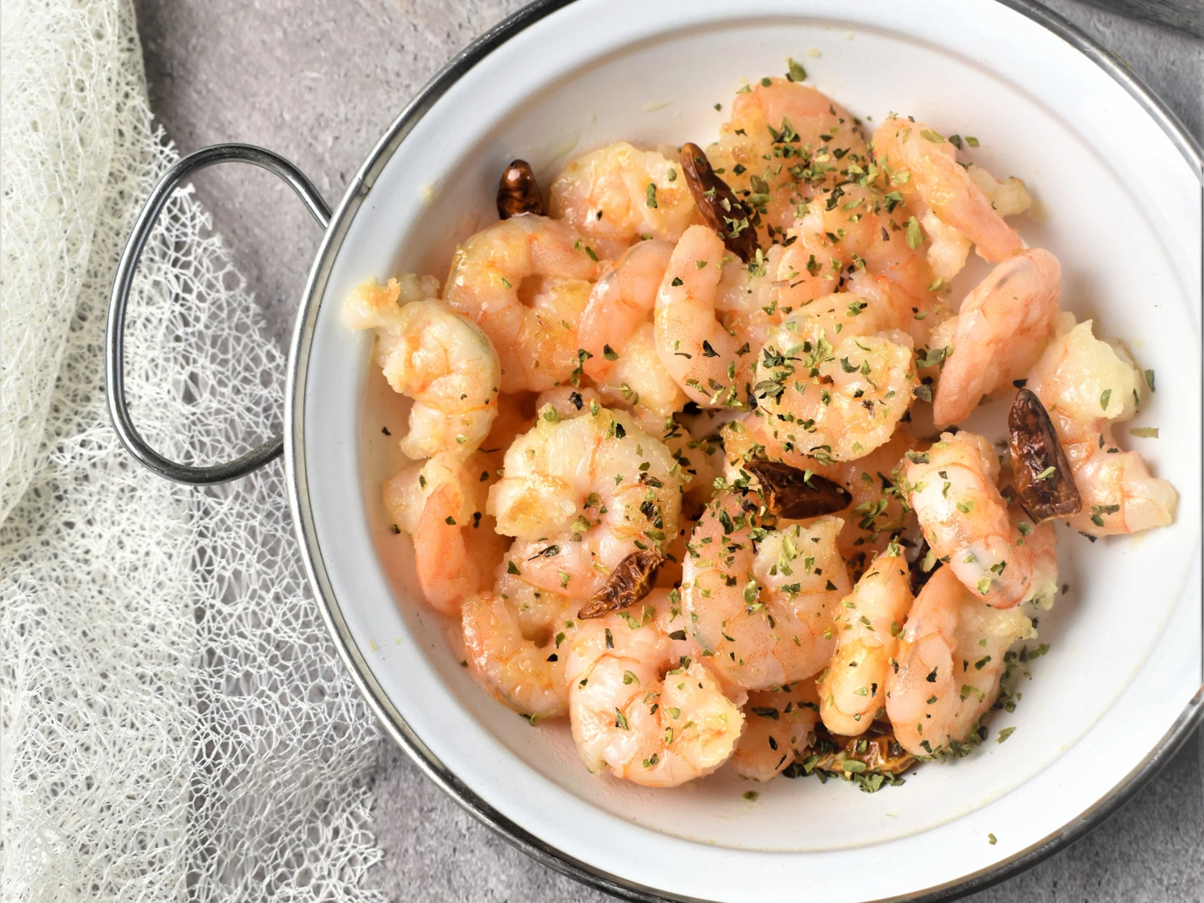 roast shrimp on a plate with thousand island dressing drizzled on top.