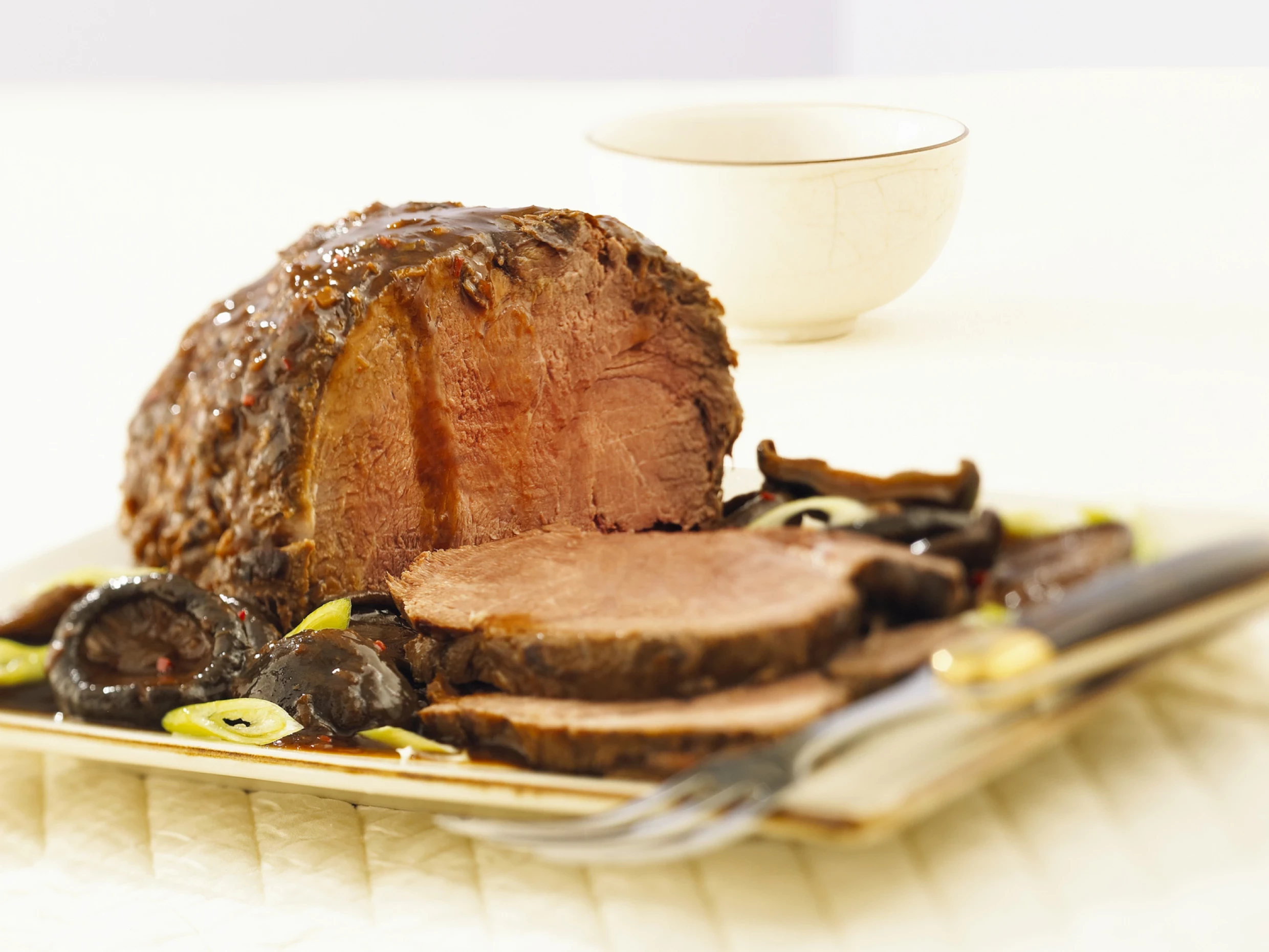 roast beef served on a plate marinated in a sweet sauce