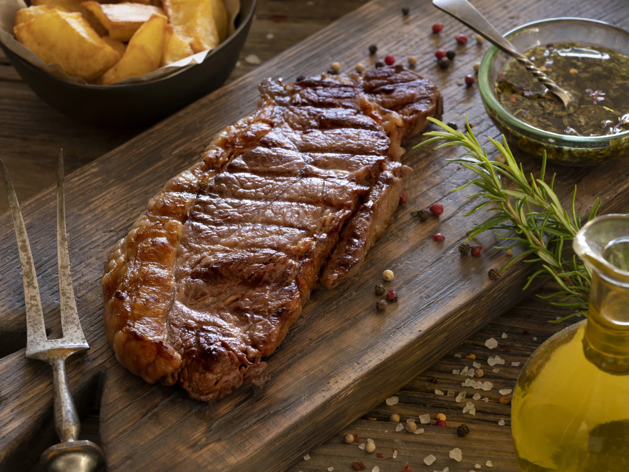 juicy, well-done steak with a chimichurri sauce on the side