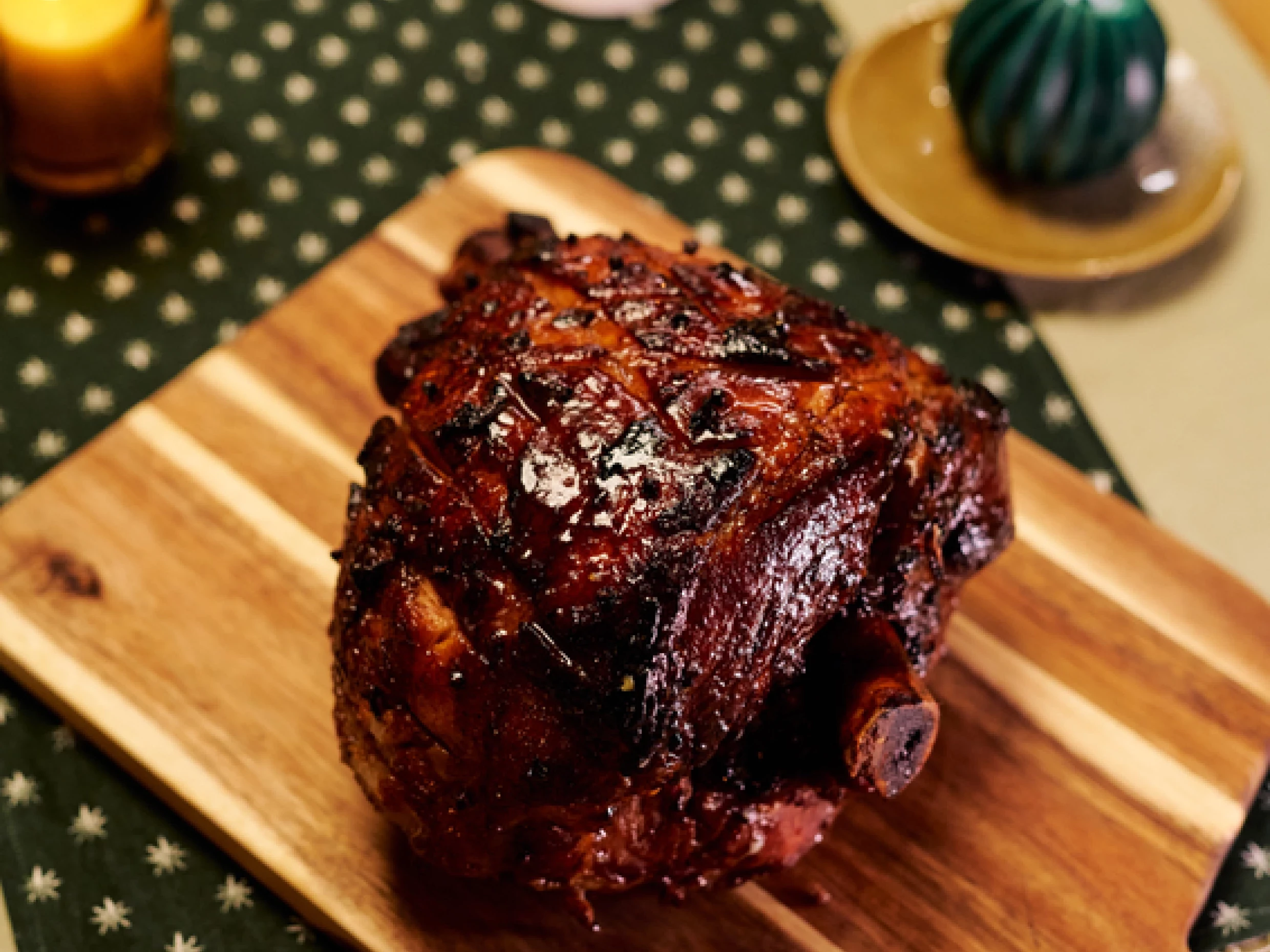 Marcus wareing's honey and tea glazed ham sitting on a chopping board