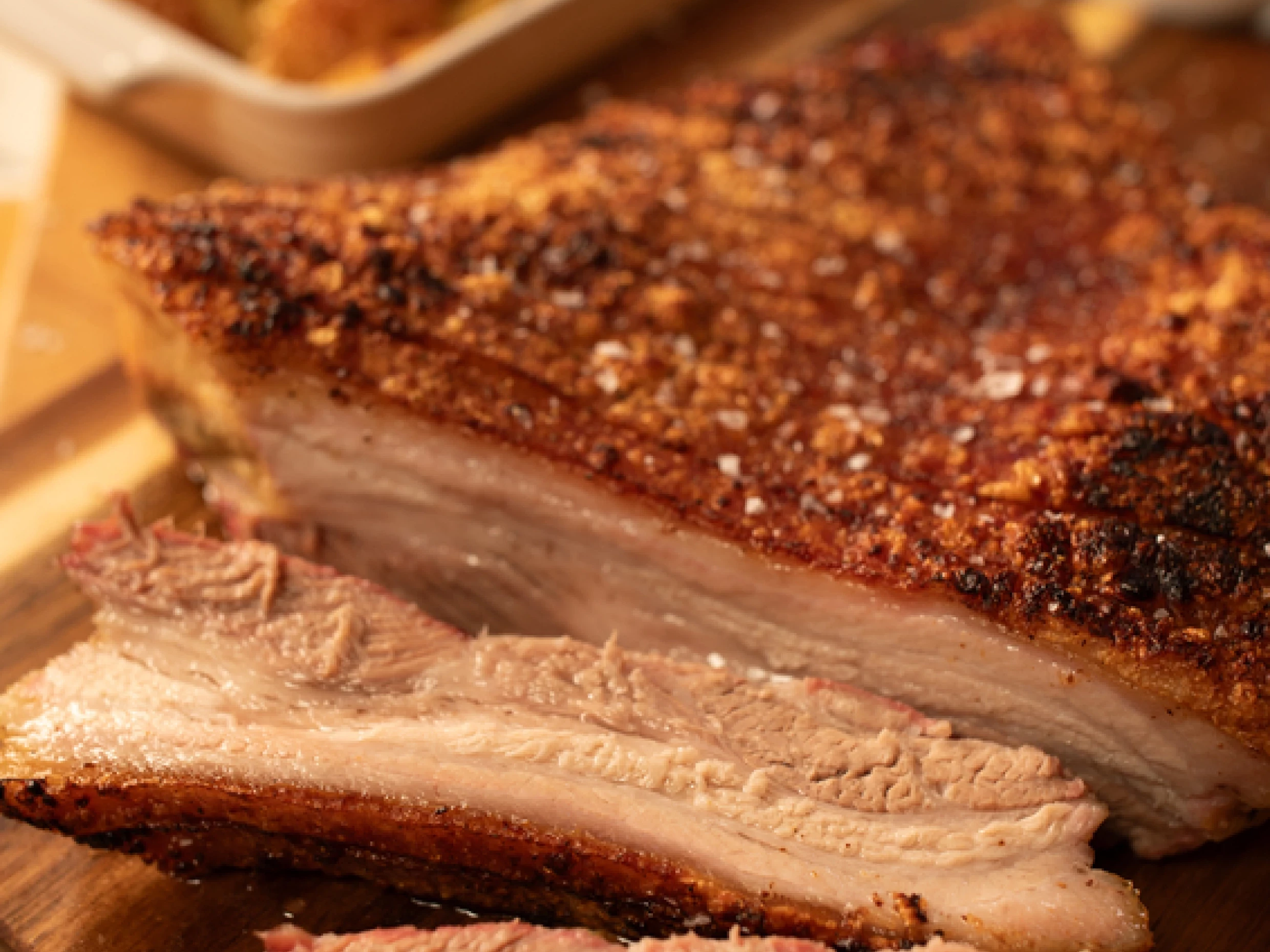 a crispy pork belly sliced on a chopping board