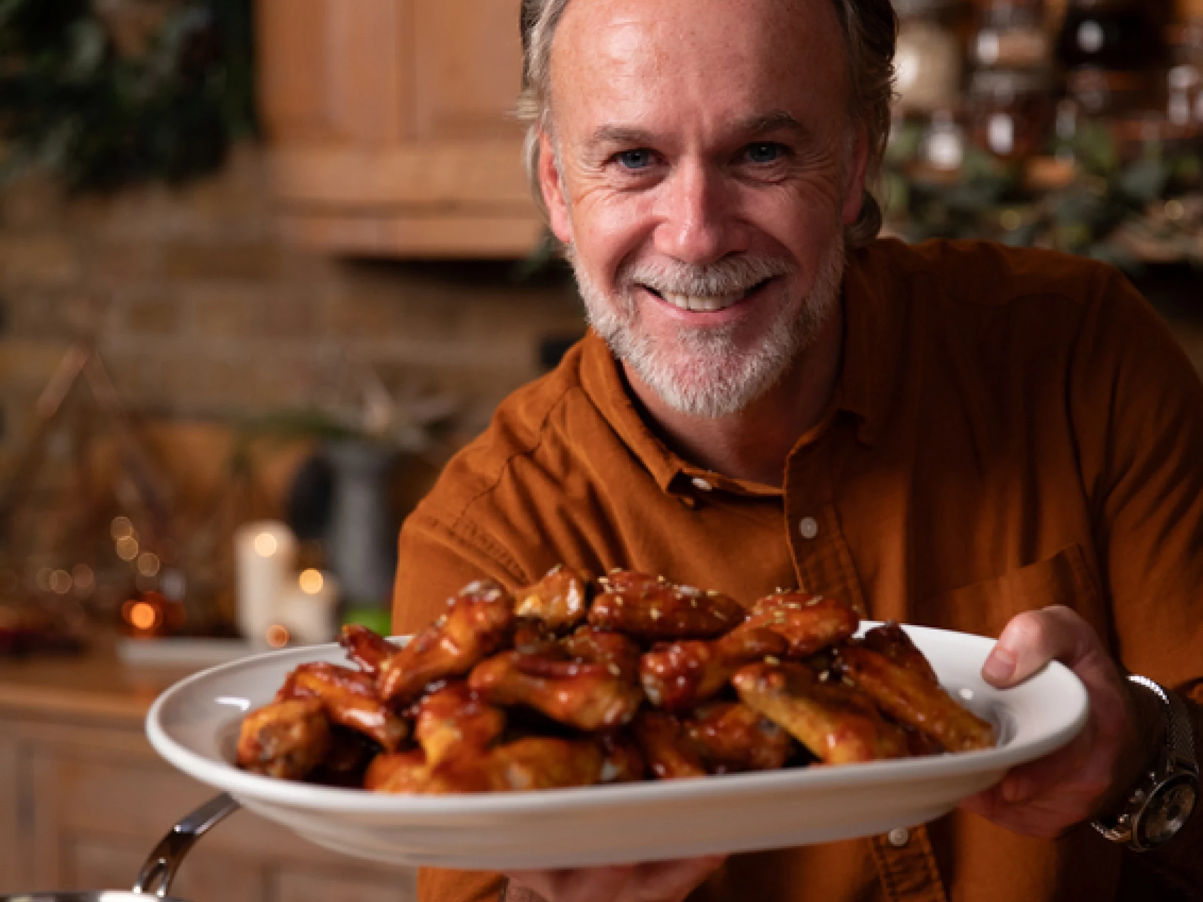 Marcus Wareing holding chicken wings